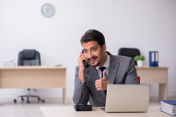 Young male employee working in the office