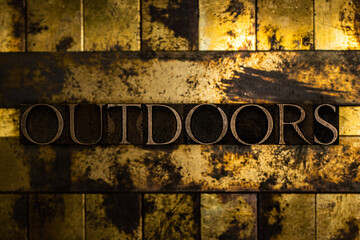 Outdoors text on vintage textured grunge copper and gold background