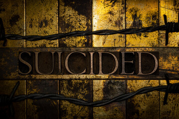 Suicided text on vintage textured grunge copper and gold background