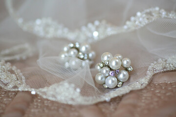 Luxury earrings for a bride or a chic woman close-up. Jewelry accessories.