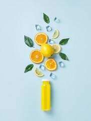 Summer tropical fruits and ice cubes as ingredients for healthy multivitamin juice. Cold refreshing drink made of lemon, lime, orange, ice, and grapefruits. Creative summer drink concept. Flat lay.