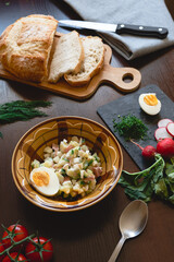 Traditional okroshka soup on kefir with egg and dill.  ingredients for okroshka on the table