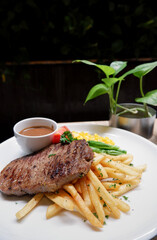 Close up homemade sirloin steak in a white plate