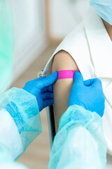 Fototapeta premium woman wearing mask getting vaccinated concept of coronavirus vaccination mask grown woman approved for covid-19 vaccination at the hospital. Female doctor immunizes against the virus, medical plaster