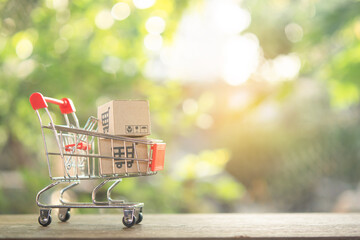 Shopping concept - Shopping cart or trolley and Paper cartons or parcel with a shopping cart logo...