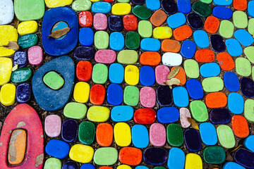 Top view on pieces of multicolored ceramic tiles decorated in garden. Old pavement of tiles textured. Street mosaic cobblestone sidewalk. Abstract,background and pattern of ceramic tile on the floor.