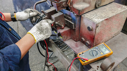 Electricient use voltmeter to measure the voltage of welding machine, Maintenence are checking the...