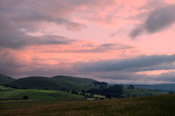 Fototapeta premium A view looking south over toward Burnsall and Thorpe Fell, in the Yorkshire Dales, North Yorkshire.