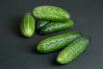 Fresh cucumbers on dark background