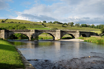 Fototapeta na wymiar Burnsall Bridge over the River Wharfe, in the Yorkshire Dales, North Yorkshire.