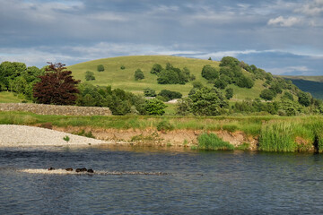 A view along the River Wharfe towards Kail Hill, in the Yorkshire Dales, North Yorkshire.