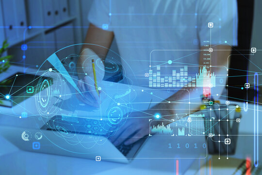 Student in casual taking notes in front of laptop conducting a research. HUDs with digital interface, information security and range of graphs and charts. Concept of technologies in education
