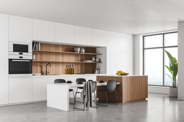 Corner view of white panoramic kitchen, table with wooden elements