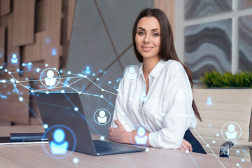 Attractive businesswoman in white shirt at workplace working with laptop to hire new employees for...