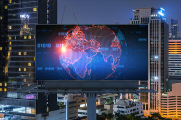 Hologram of Earth planet map on billboard over night panoramic cityscape of Bangkok. The concept of international companies in Southeast Asia.