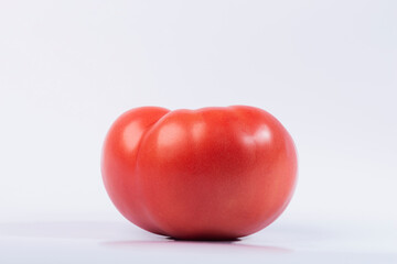 Tomato on a white isolated background. 