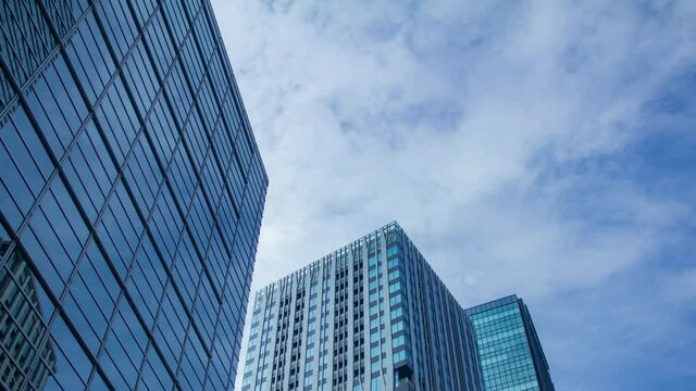 A timelapse of clowd at the building in the business town wide shot panning