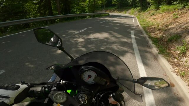 POV Motorcyclist driving too fast on the asphalt road with multiple consecutive curves