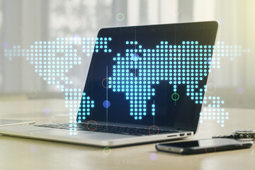 Double exposure of abstract digital world map on laptop background, research and strategy concept