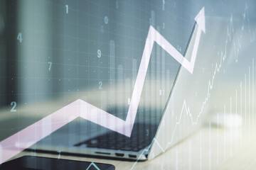 Double exposure of abstract creative financial chart with upward arrow on laptop background,...