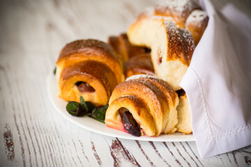 baked sweet homemade buns with plum inside