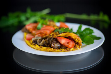fried egg omelet with wild mushrooms and tomatoes
