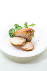 baked chicken fillet pieces with spices and herbs, in a ceramic form