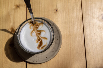 Fototapeta premium Latte macchiato with latte art on a wooden table 