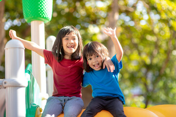 Child playing on the outdoor playground. Kids play in school or kindergarten yard.