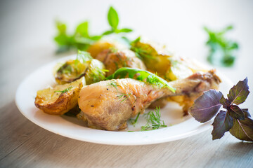 baked chicken leg with early potatoes and zucchini