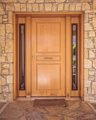 contemporary house front entrance natural wood door and stone wall