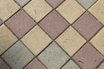 concrete floor with colored tiles forming rhombuses