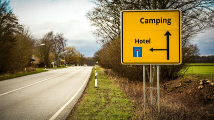 Street Sign to Camping versus Hotel