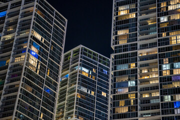 Fototapeta na wymiar Highrise condos in the city lit at night