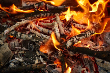 flames of burning firewood with glowing charcoal and white ash