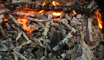 campfire flames and hot smoldering glowing coals with white ash