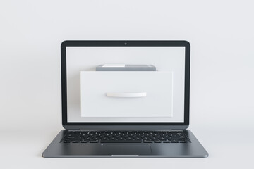 Close up of notebook computer with abstract document folder coming out of screen on white...