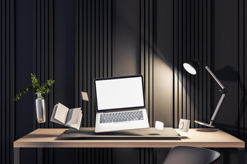 Fototapeta na wymiar Dark hipster office interior with empty white laptop screen and other objects flying above desktop. Mock up, 3D Rendering.