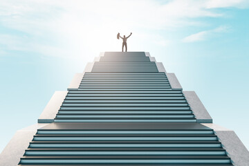 Obraz premium Happy businessman standing on top of staircase on bright sky background. Success and achievement concept.