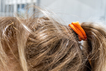 Close-up of hair tied with a rubber band.