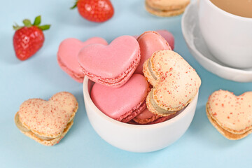 Bowl with heart shaped French macaron sweets