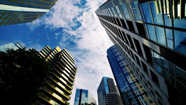 A timelapse of clowd at the building in the business town wide shot tilt