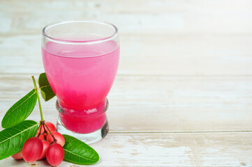 Iced Karanda fruit juice Put down a glass, Bengal-Currants, Carandas-plum, Karanda, Carissa carandas L, Is a fruit with high medicinal properties.	