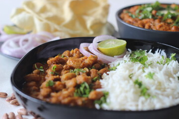 Red kidney beans in a thick and spicy gravy of onions and tomatoes served along with steamed basmati rice and papad. Commonly known as rajma masala and chawal in the northern parts of India.