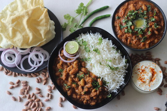 Red kidney beans in a thick and spicy gravy of onions and tomatoes served along with steamed basmati rice and papad. Commonly known as rajma masala and chawal in the northern parts of India.