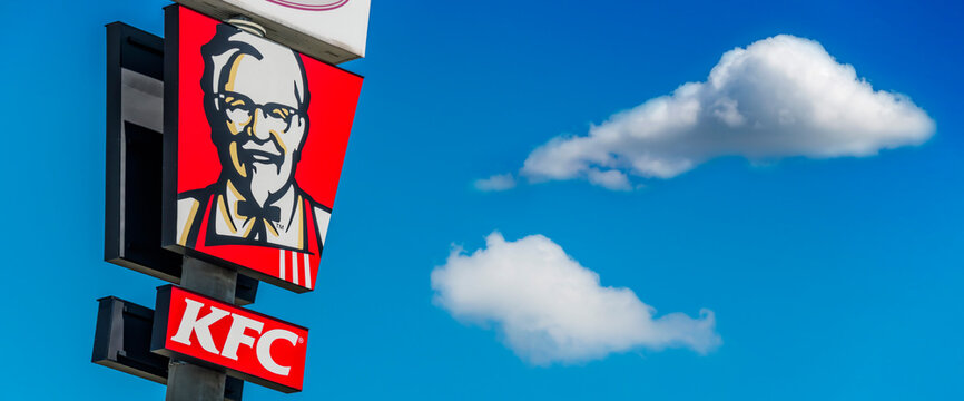 Kentucky Fried Chicken Pylon Sign Over Blue Sky