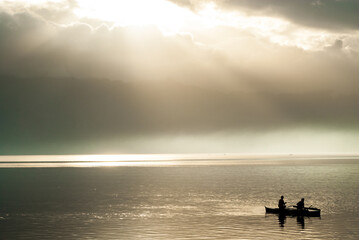 Naklejka na ściany i meble silhouette of a couple on a boat