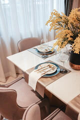 The cozy dining table is elegantly decorated in rose gold tones