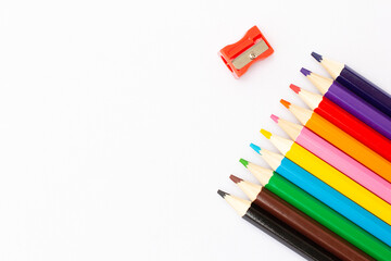close up of colour pencils isolated on white background .