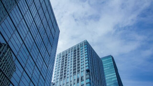 A timelapse of clowd at the building in the business town wide shot zoom